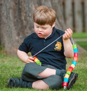 Boy playing with a colourful toy at Kidscene