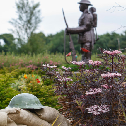 Linburn Centre garden with Tommy statue and WWI trench bags and helmet
