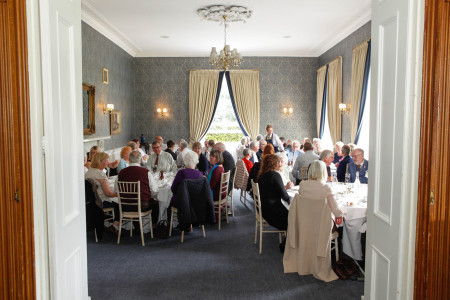 Veterans and guests enjoy a formal lunch in hotel dining room