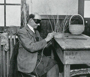 A blind veteran makes at basket at Newington House