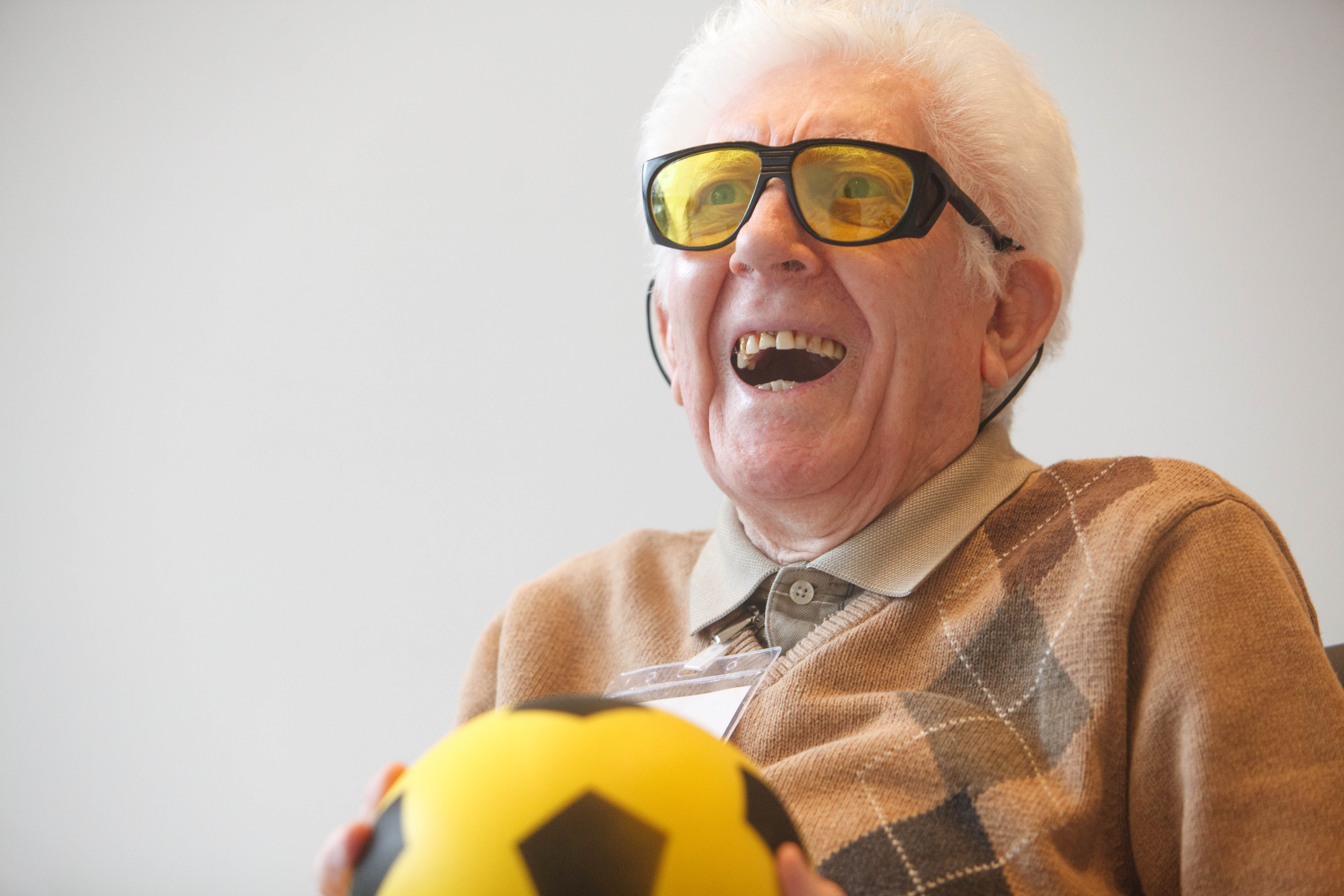 Veteran catches ball in strength and balance class at Hawkhead Centre