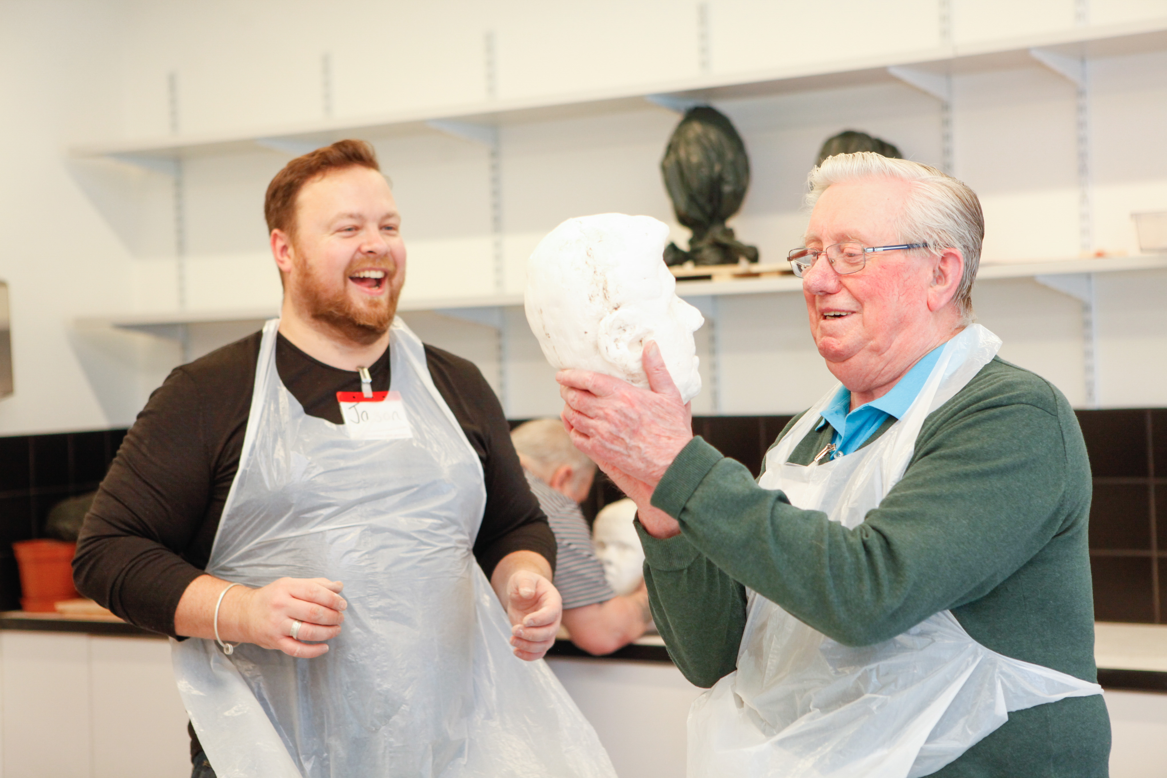 Art volunteer with veteran working on sculpture in Hawkhead Centre art room