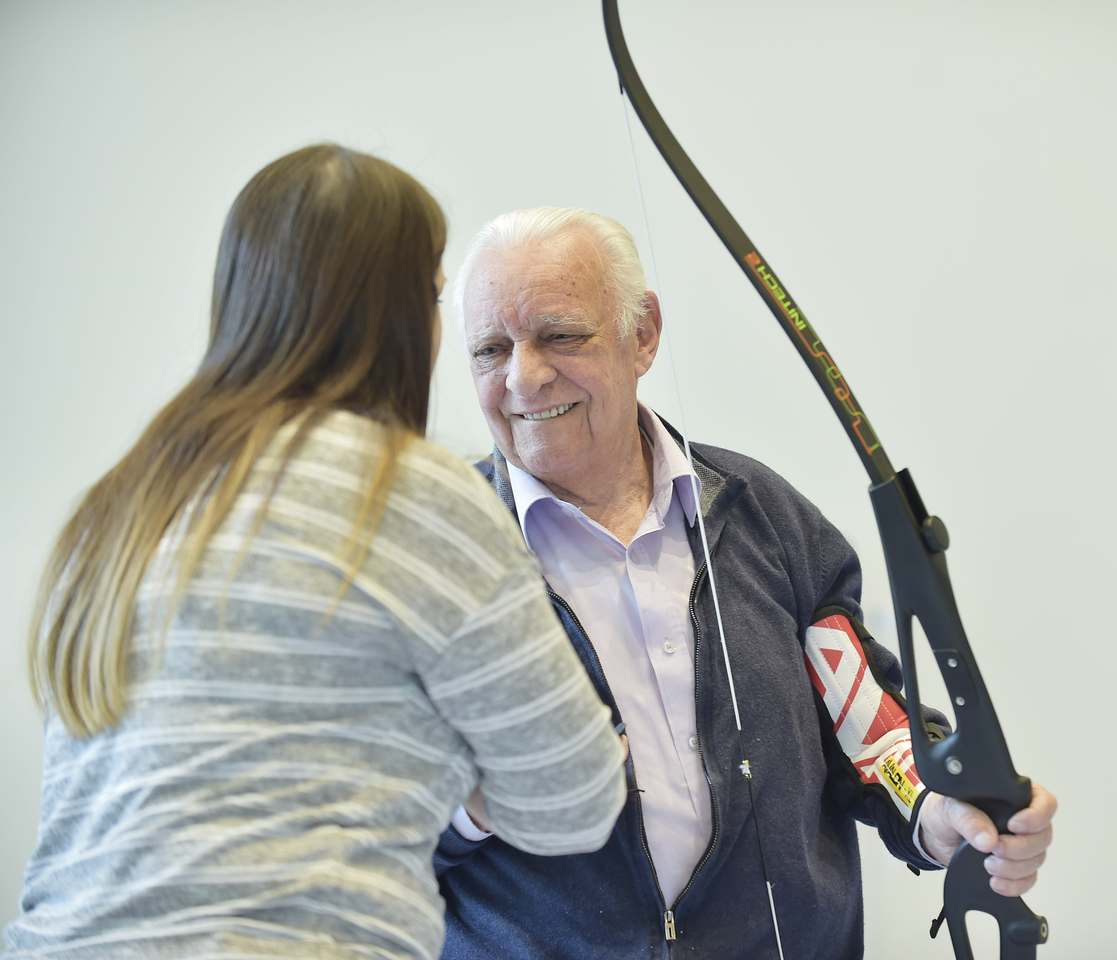 Veteran with sight loss holds archery bow