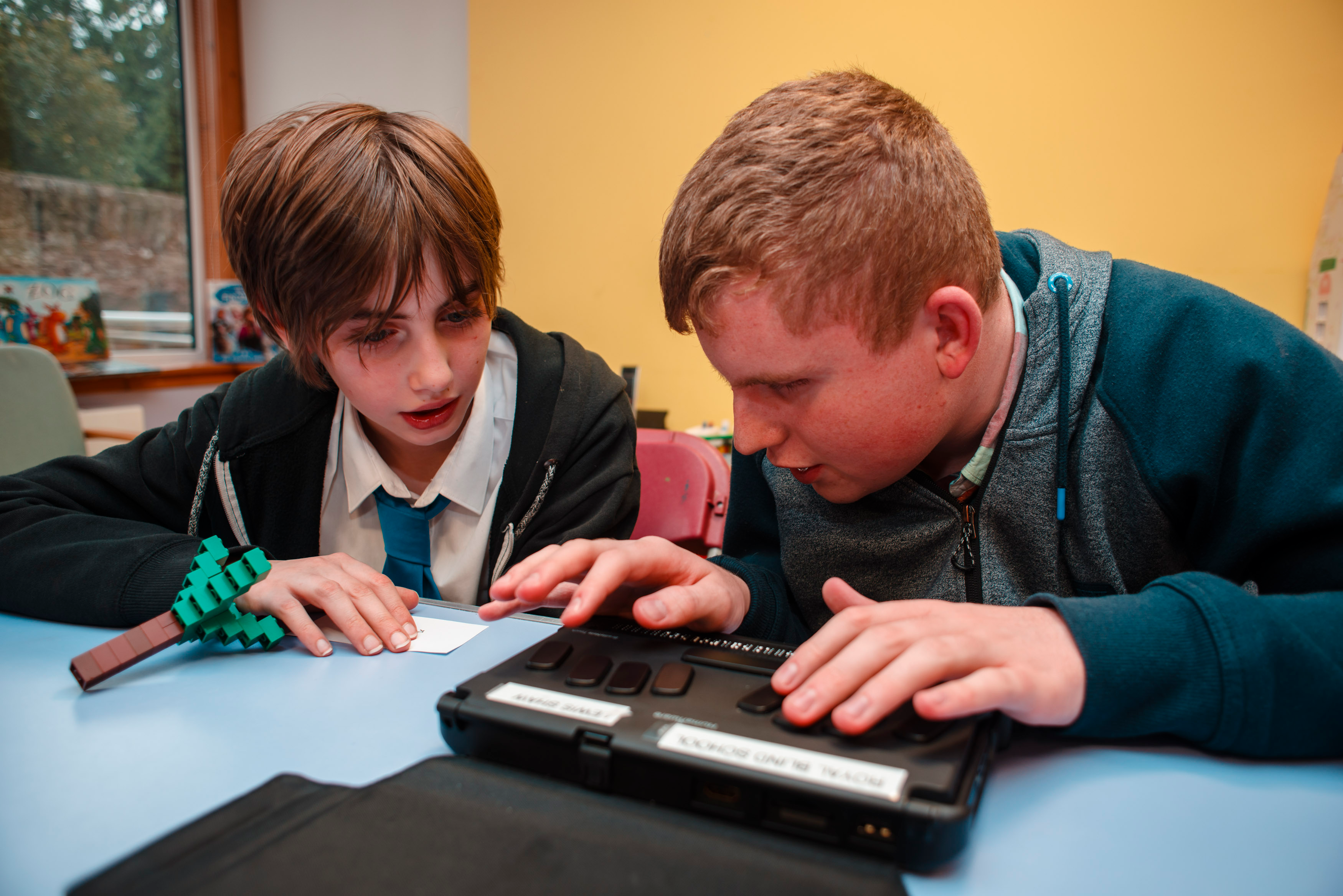 Royal Blind School residential pupils use a BrailleNote device to read braille