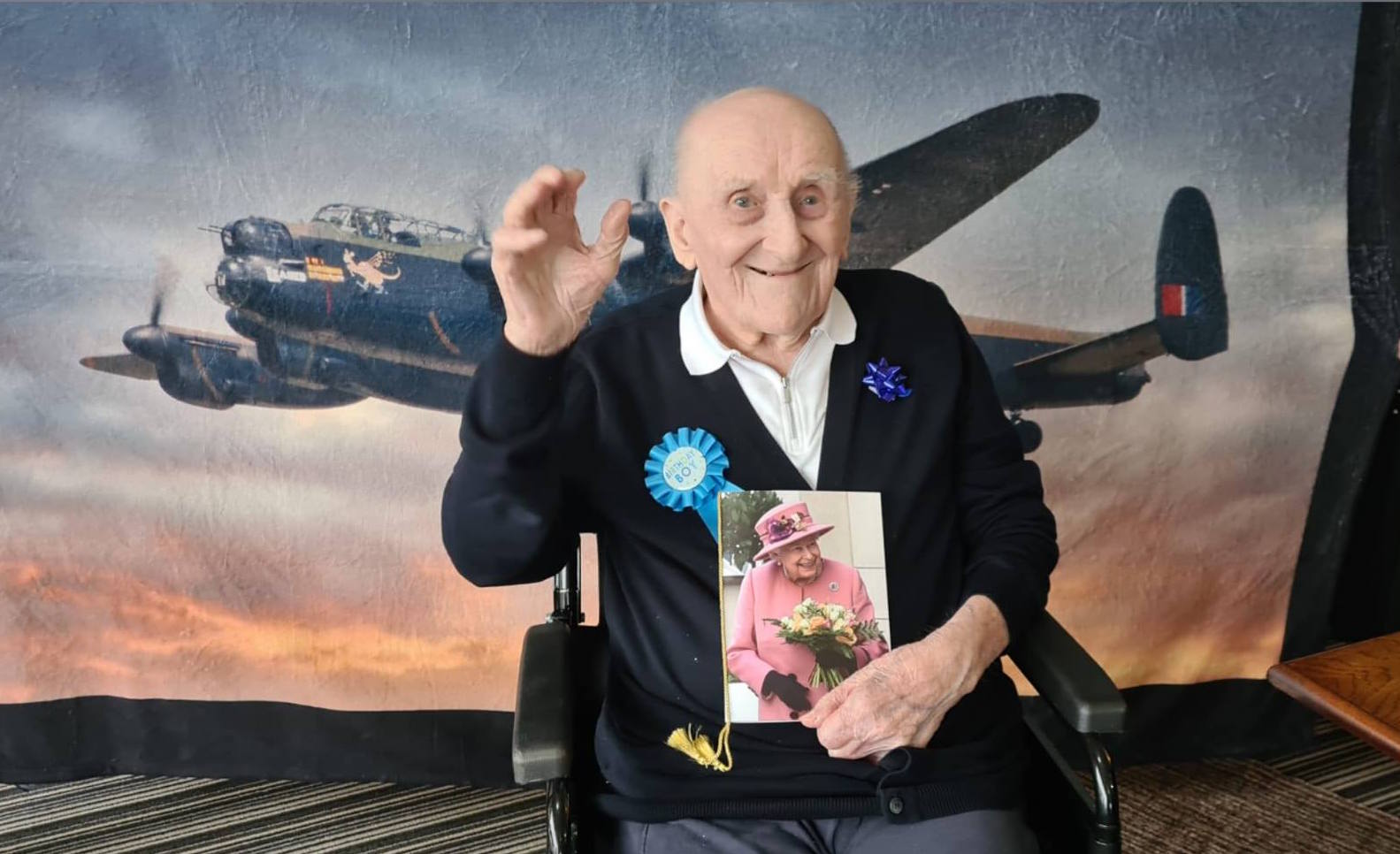 RAF veteran James Crook Veteran James Crook waves while holding his birthday card from the Queen