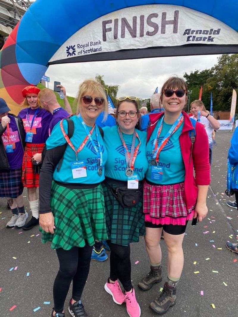 Three Kiltwalkers at the finish line