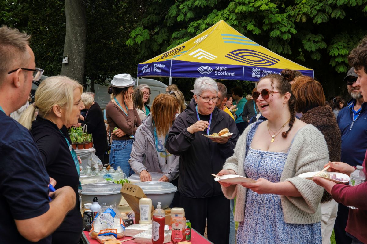 A queue forms in front of the barbeque station in the school's garden