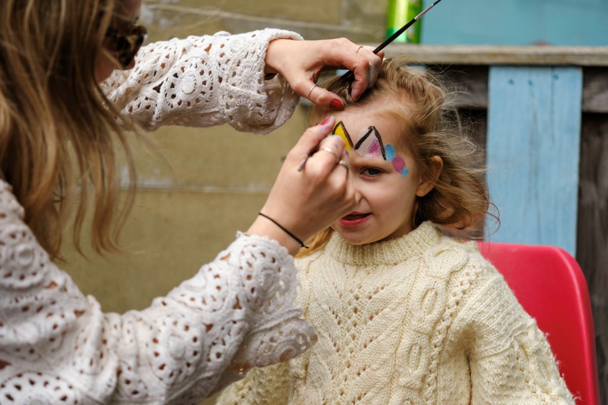 A young girl gets her face painted