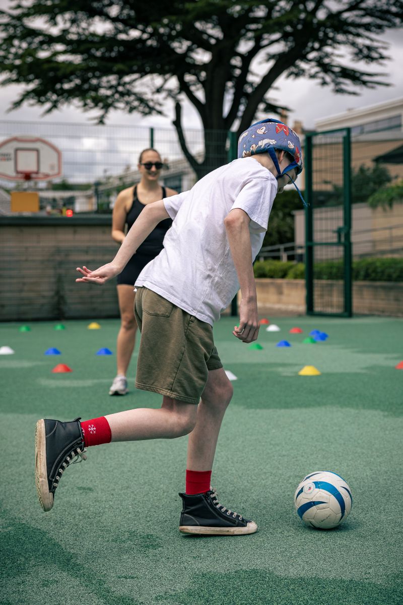 One of the pupils chases a ball across the football pitch