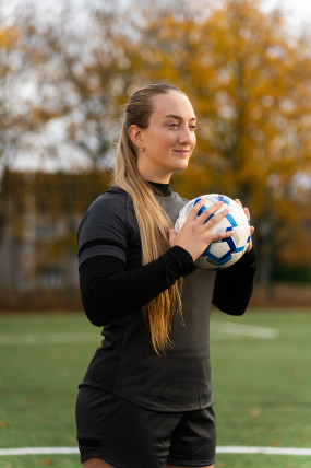 Service user Sam Gough holding a football