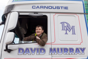 Veteran Charles smiles out the window of a David Murray HGV