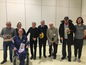 Members of the Linburn Choir stand together with some holding musical instruments