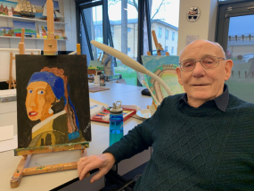 Gerry (right) in the Hawkhead art room with one of his paintings