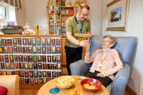 Manager Stewart hands a resident a drink