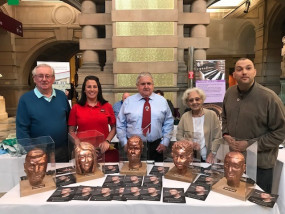 Veterans proudly pose with their self-portrait sculptures at the Kelvingrove Museum