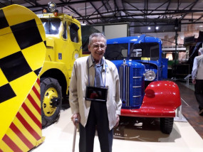 A Scottish War Blinded veteran stands in front of transport museum exhibit