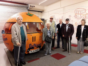 Scottish War Blinded veterans with an orange-shaped car at transport museum