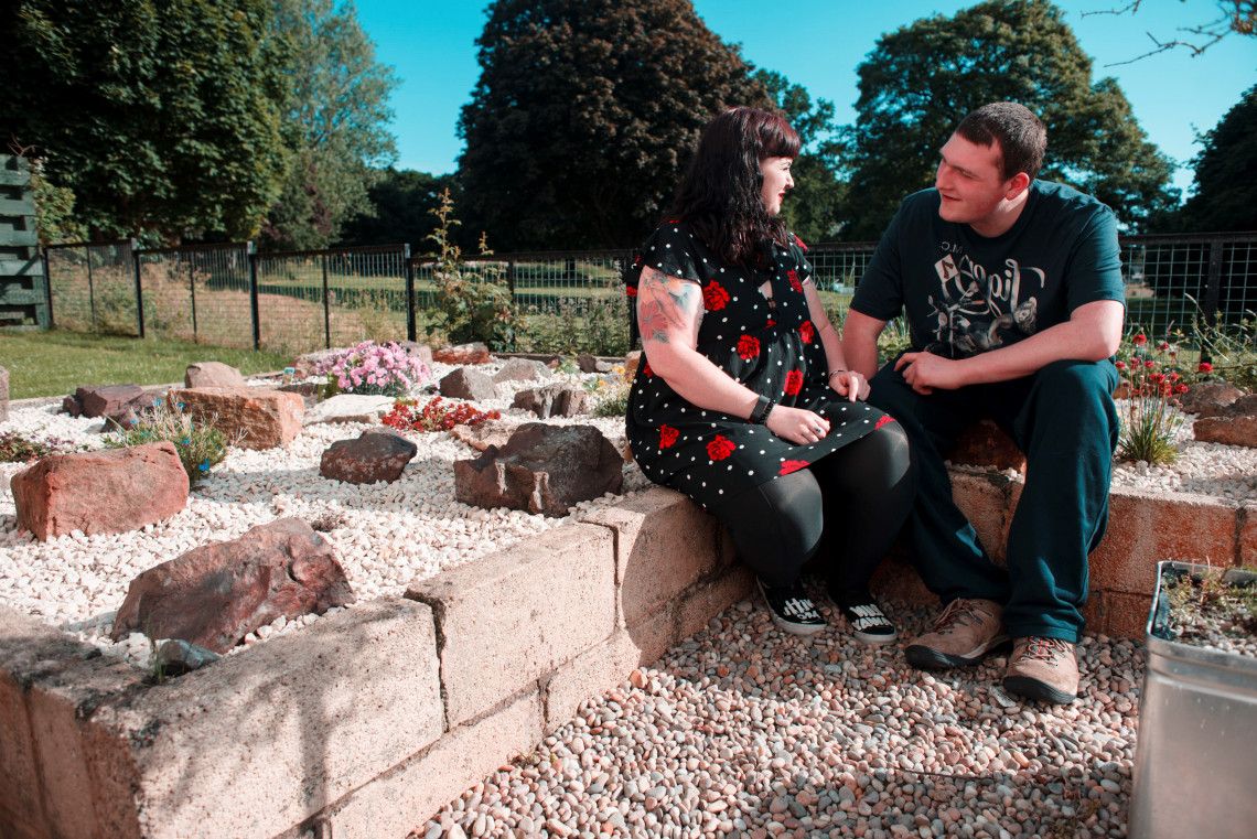 Allemuir resident and a staff member talk in the garden