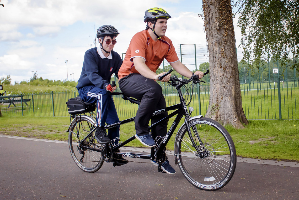 Andrew cycling with David, Royal Blind School's PE teacher 