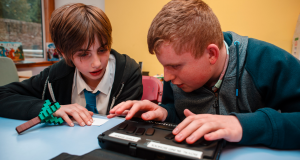 Royal Blind School residential pupils use a BrailleNote device to read braille