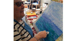 A Braeside House resident painting a picture.