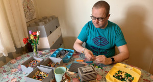 Fundraiser Stewart Lamb Cromar wears Lego t-shirt and builds with Lego