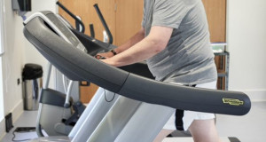 Man in gym using treadmill