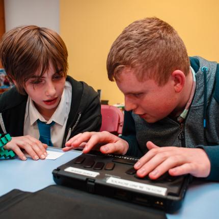 Royal Blind School residential pupils use a BrailleNote device to read braille