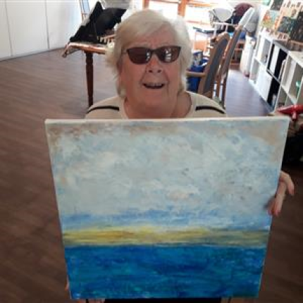 A Braeside House resident with a painting they painted