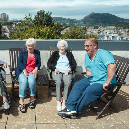 Braeside House residents relax in group on rooftop